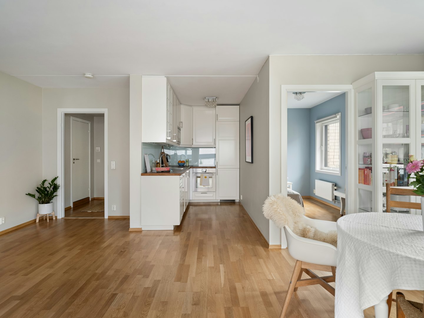 Modern open plan living area with a white kitchen.