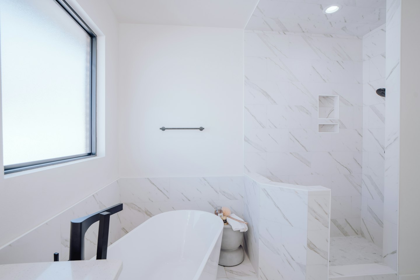 Modern bathroom featuring a freestanding tub and walk-in shower.