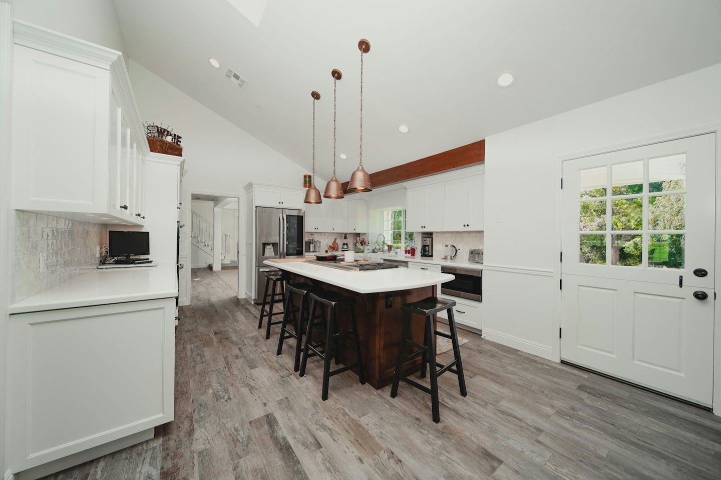 Modern kitchen with white cabinets and a large island.